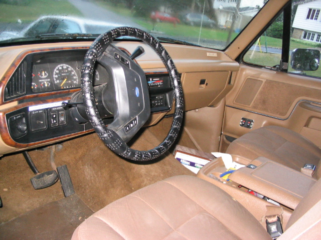 1986 Ford Bronco interior with tan seats and dashboard