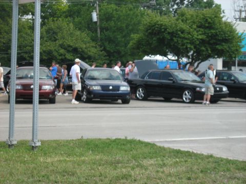 1988 Mercury Grand Marquis - Multiple Mercury Grand Marquis sedans are gathered, with one in dark blue having its hood open.