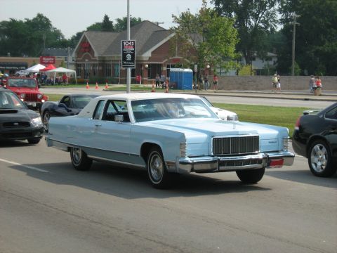 1988 Mercury Grand Marquis - Light blue 1975 Lincoln Town Car with white vinyl roof seen in traffic.