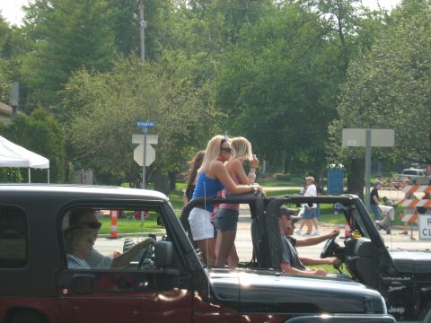 1988 Mercury Grand Marquis - People enjoy a sunny day riding in a Jeep Wrangler, with another Jeep visible.