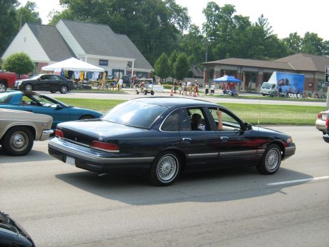 1988 Mercury Grand Marquis - A dark blue sedan is seen from the rear, appearing to be from the 1992 model year.