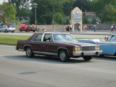 1988 Mercury Grand Marquis - A maroon 1988 Mercury Grand Marquis sedan is seen from the front-three-quarter angle during the Woodward Cruise 2009.