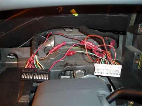 2003 Ford Crown Victoria - Close-up view of a vehicle's interior wiring harness and connectors, likely during an installation or repair.