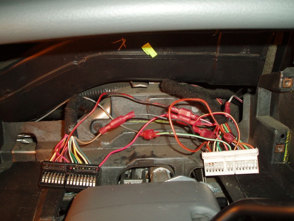 fully connected, notice tach wire coming up from the left, connected to the light green/white wire in the white connector and the white/red wire going down to be wired into the marauder gauge pod. also used two T-taps for the dupe wires.

** there are other ways of wiring it up, i liked this way, just in case i had to go back to the original cluster, it would have been easy to do.