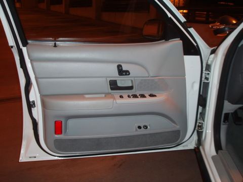 2003 Ford Crown Victoria - Owner's manual stored in the door pocket of a car.