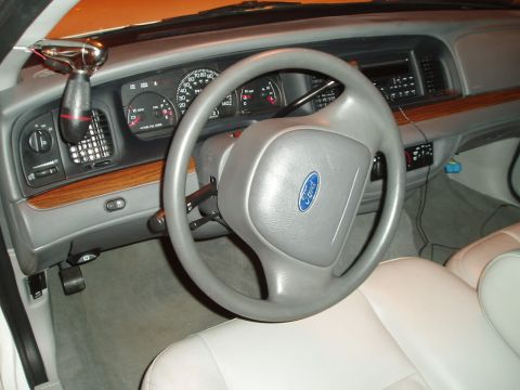 2003 Ford Crown Victoria - Interior view of a 2003 Ford Crown Victoria, highlighting the dashboard and steering wheel.