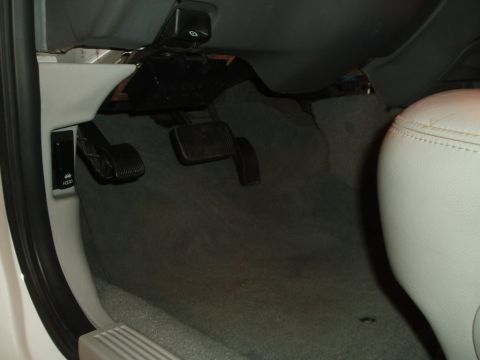 2003 Ford Crown Victoria - A view of the interior passenger side door and seat of a vehicle.