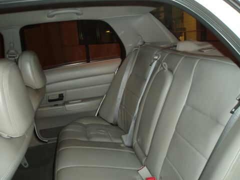 2003 Ford Crown Victoria - The rear seating area of a light-colored SUV is shown, highlighting the upholstery and seat configuration.