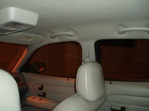 2003 Ford Crown Victoria - The interior of a vehicle is shown, with a focus on the seating and window areas.