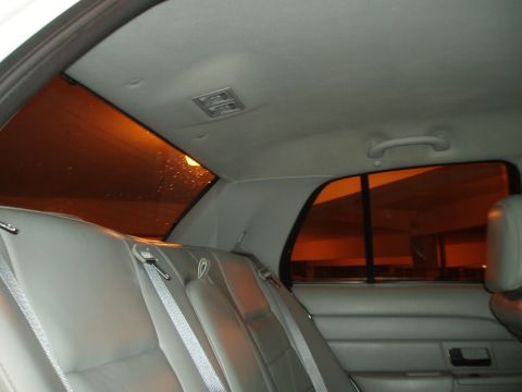 2003 Ford Crown Victoria - Rear interior view of a 2003 Ford Crown Victoria, showing the seats and tinted windows.