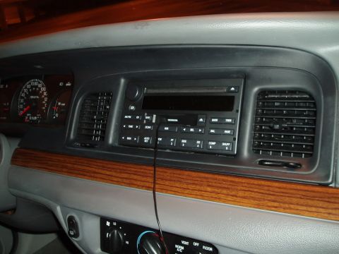 2003 Ford Crown Victoria - Dashboard view of a 2003 Ford Crown Victoria, showing the center console with radio and air vents.