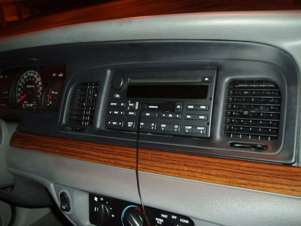 Crown Victoria dashboard with factory cassette/CD radio, woodgrain trim and gauge cluster