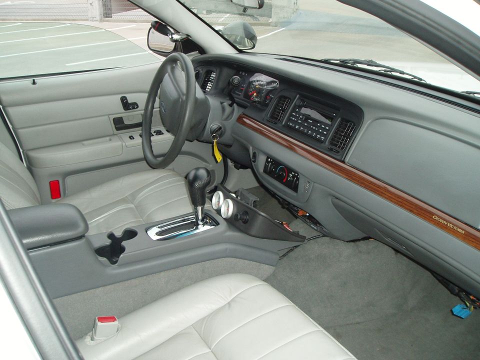 Gray Crown Victoria interior with floor shifter, console gauges and wood dash trim