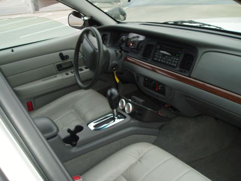 2003 Ford Crown Victoria - Interior view of a 2003 Ford Crown Victoria, highlighting the dashboard and seating.