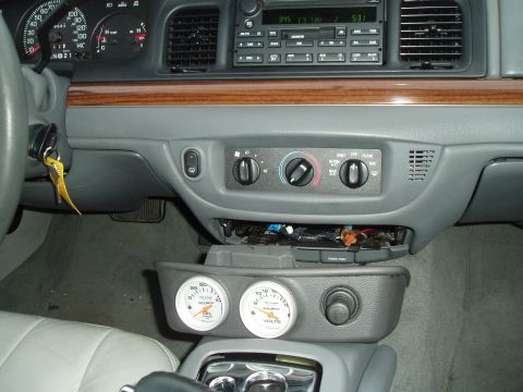 2003 Ford Crown Victoria - Interior view of a 2003 Ford Crown Victoria, aftermarket gauges installed on the center console.