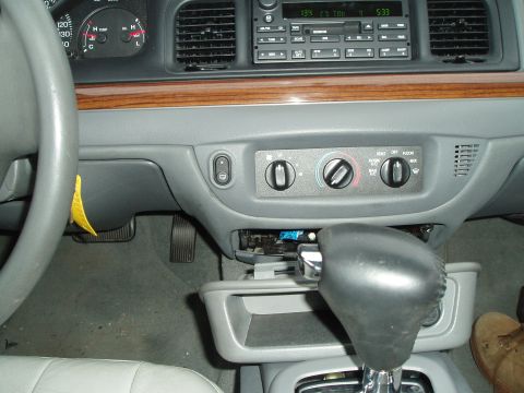 2003 Ford Crown Victoria - The interior of a 2003 Ford Crown Victoria, the dashboard, climate controls, and gear shifter.