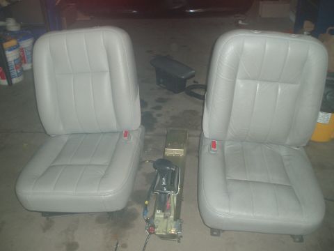 2003 Ford Crown Victoria - Car seats and center console removed from a vehicle, likely for repair or upgrade.