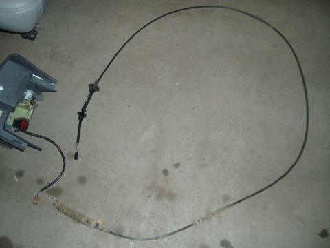 2003 Ford Crown Victoria - Parking brake cable and console trim removed from a vehicle.