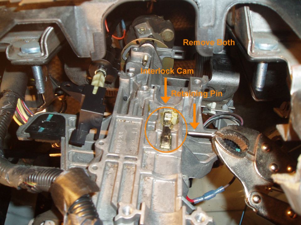 This part was the hardest, i started by taking a thick flat head screw driver on the other end of the pin (left side) and bending it at an angle causing the pin to slowly push its way out until there was enough showing to pull it out with a pliers, the interlock cam can than be removed. the cam is no longer needed, you can reuse the pin, if you don't have the floor interlock screw.