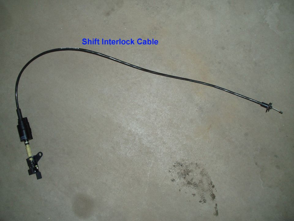 Black shift interlock cable laid on concrete floor with text label