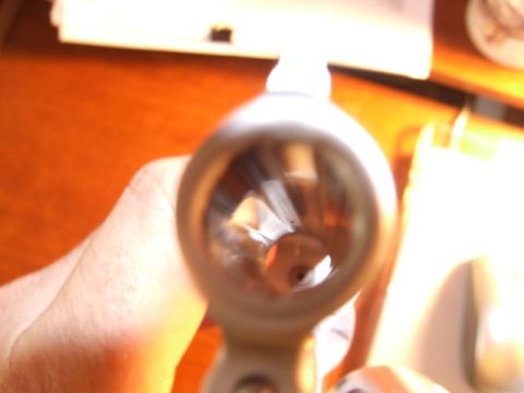 2002 Jeep TJ - A close-up view into the rifled interior of a gun barrel, held by a hand.