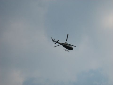 1988 Mercury Grand Marquis - A helicopter is seen flying in the sky during the Woodward Cruise 2009 event.