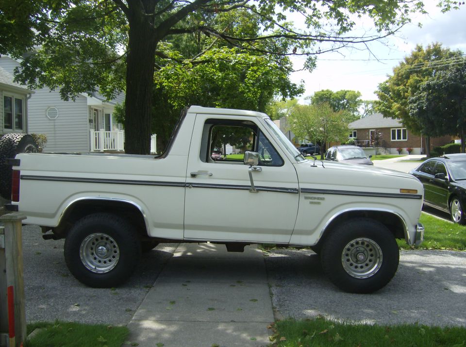 1985 Ford Bronco parked on a driveway, side view