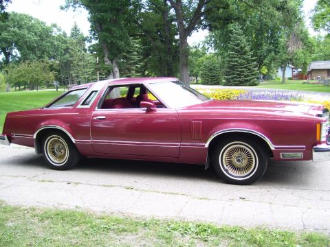 1979 Ford Thunderbird - This maroon coupe with gold wheels appears to be a 1977 Ford Thunderbird, not a 1979 model.