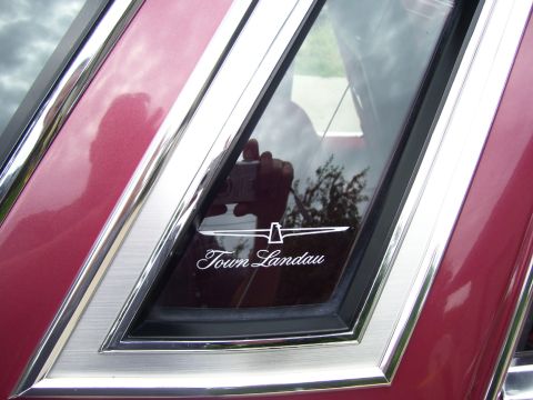 1979 Ford Thunderbird - A close-up of a car's rear side window displays the 'Town Landau' emblem.