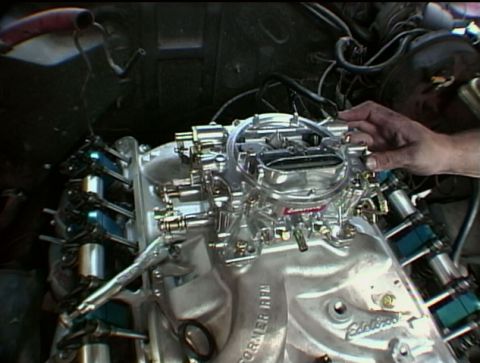 1967 Ford Galaxie - Installing a new Holley carburetor onto an Edelbrock intake manifold on an engine.