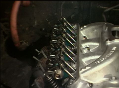 1967 Ford Galaxie - The image shows a close-up view of an engine's valve train components, including rocker arms and pushrods.