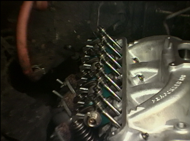 Exposed engine valvetrain with rocker arms, springs and pushrods on a cylinder head