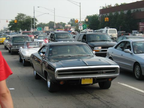 1988 Mercury Grand Marquis - A line of cars, including a classic Dodge Charger, are stuck in traffic on a sunny day.