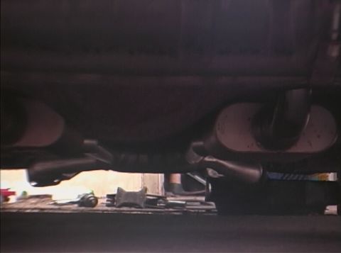1967 Ford Galaxie - Underside view of a vehicle's exhaust system, dual mufflers and angled tailpipes.
