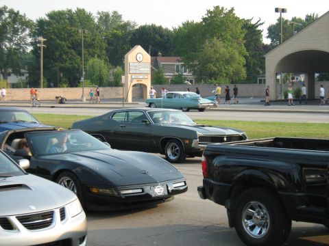 1988 Mercury Grand Marquis - A collection of vehicles, including classic cars and a pickup truck, are parked together on a sunny day.