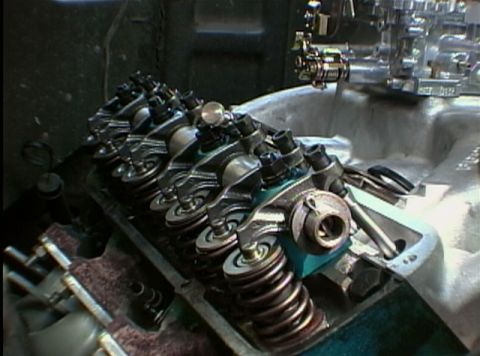 1967 Ford Galaxie - The internal components of an engine's valve train are visible, including rocker arms and springs.