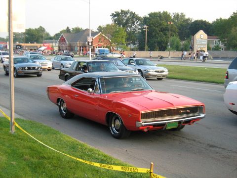 1988 Mercury Grand Marquis - A red 1968 Dodge Charger is seen in traffic on a sunny day, with other vehicles around it.