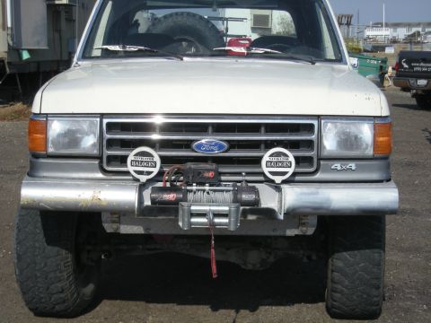 1991 Ford Bronco - Front view of a 1991 Ford Bronco equipped with a winch and halogen lights.