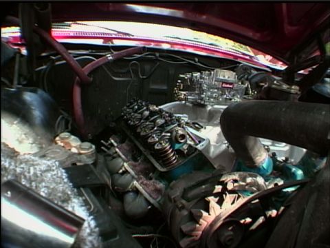 1967 Ford Galaxie - Close-up view of a vehicle's engine compartment, showing the carburetor and valve train.
