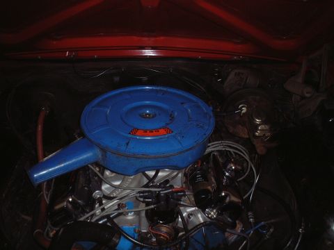 1967 Ford Galaxie - Close-up of a vehicle's engine bay, focusing on the air cleaner and surrounding components.