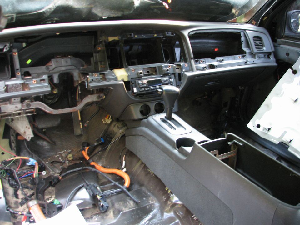 1999 Ford Crown Victoria interior with dashboard removed, showing wiring and center console