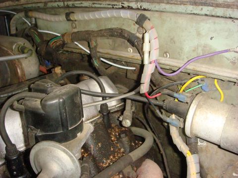 1967 Land Rover Land Rover - Close-up view of the engine bay wiring, distributor, and ignition coil.