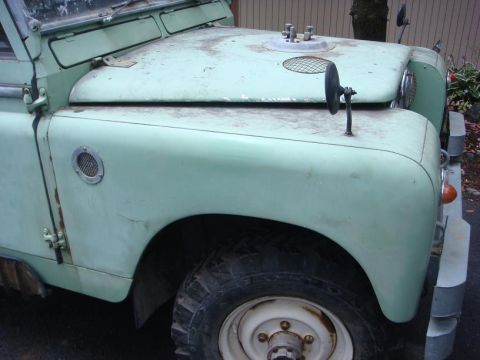 1967 Land Rover Land Rover - Front view of a 1967 Land Rover Land Rover showing the fender, hood, and side mirror.