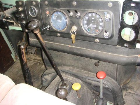 1967 Land Rover Land Rover - Close-up of the interior dashboard and center console of a Land Rover, showing multiple gear levers and instrumentation.