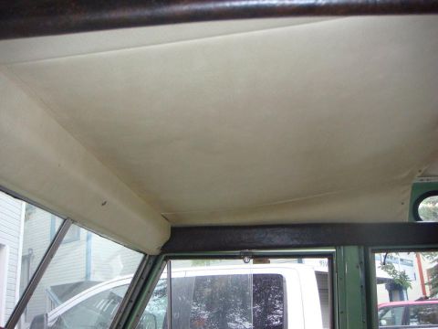 1967 Land Rover Land Rover - View of the interior headliner and side window, with another vehicle parked nearby.