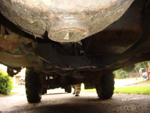 1967 Land Rover Land Rover - A low-angle shot captures the undercarriage of a vehicle, revealing its mechanical components and tires.
