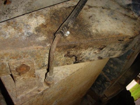 1967 Land Rover Land Rover - Detail of a corroded vehicle chassis showing a brake line and clamp.