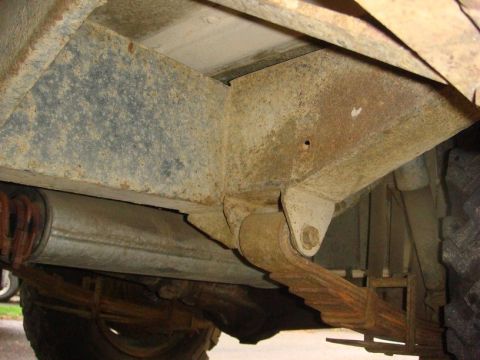 1967 Land Rover Land Rover - Close-up of the undercarriage, focusing on the suspension and exhaust system.