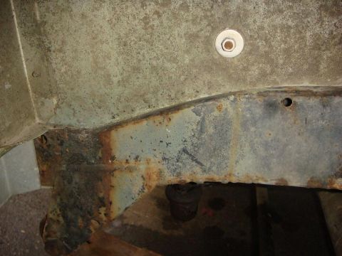 1967 Land Rover Land Rover - The underside of a vehicle shows significant rust and wear on its frame components.