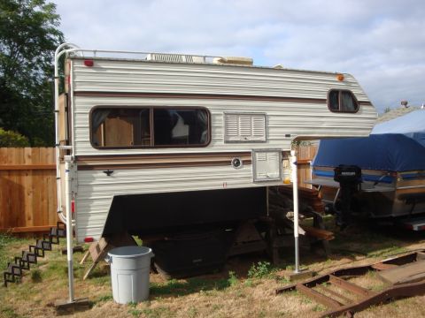 1988 Ford F-350 - Slide-in truck camper with brown stripes and a ladder on the side.